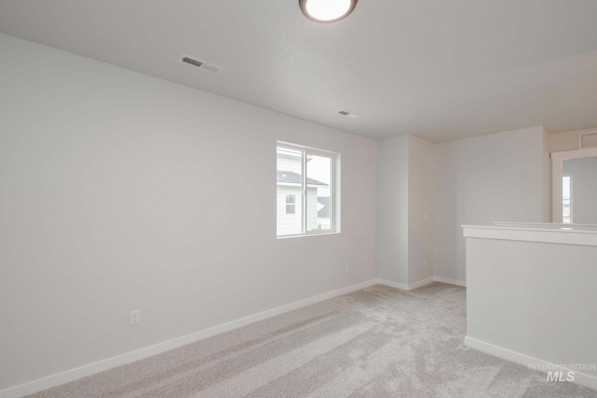 4155 North Delphi Avenue Meridian, ID 83646 - Photo 18 of 24 Unfurnished room with light carpet and baseboards