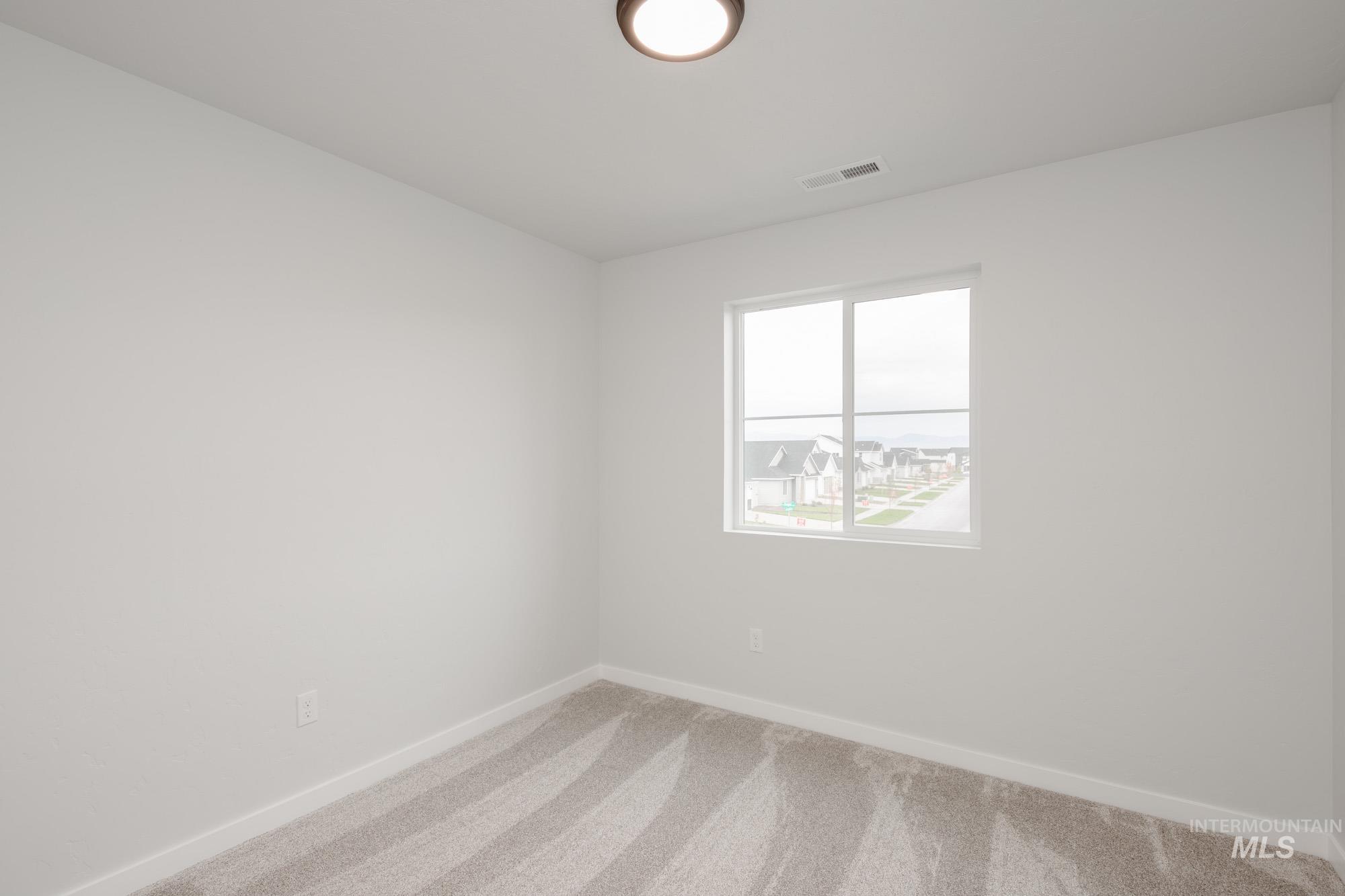 4155 North Delphi Avenue Meridian, ID 83646 - Photo 19 of 24 Spare room with carpet floors and baseboards