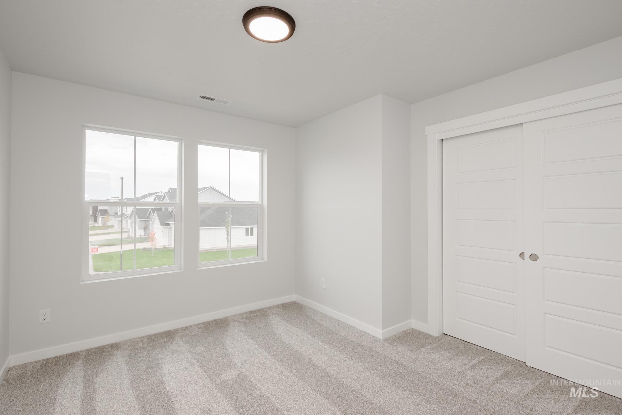 4155 North Delphi Avenue Meridian, ID 83646 - Photo 20 of 24 Unfurnished bedroom featuring light colored carpet and a closet