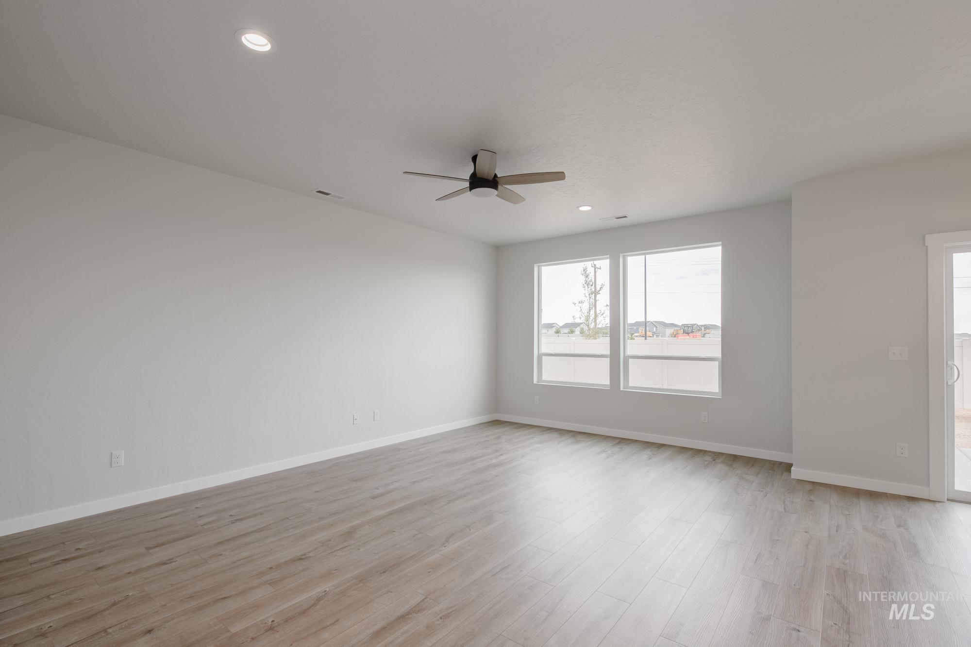 4155 North Delphi Avenue Meridian, ID 83646 - Photo 7 of 24 Spare room with light wood finished floors, recessed lighting, and a ceiling fan