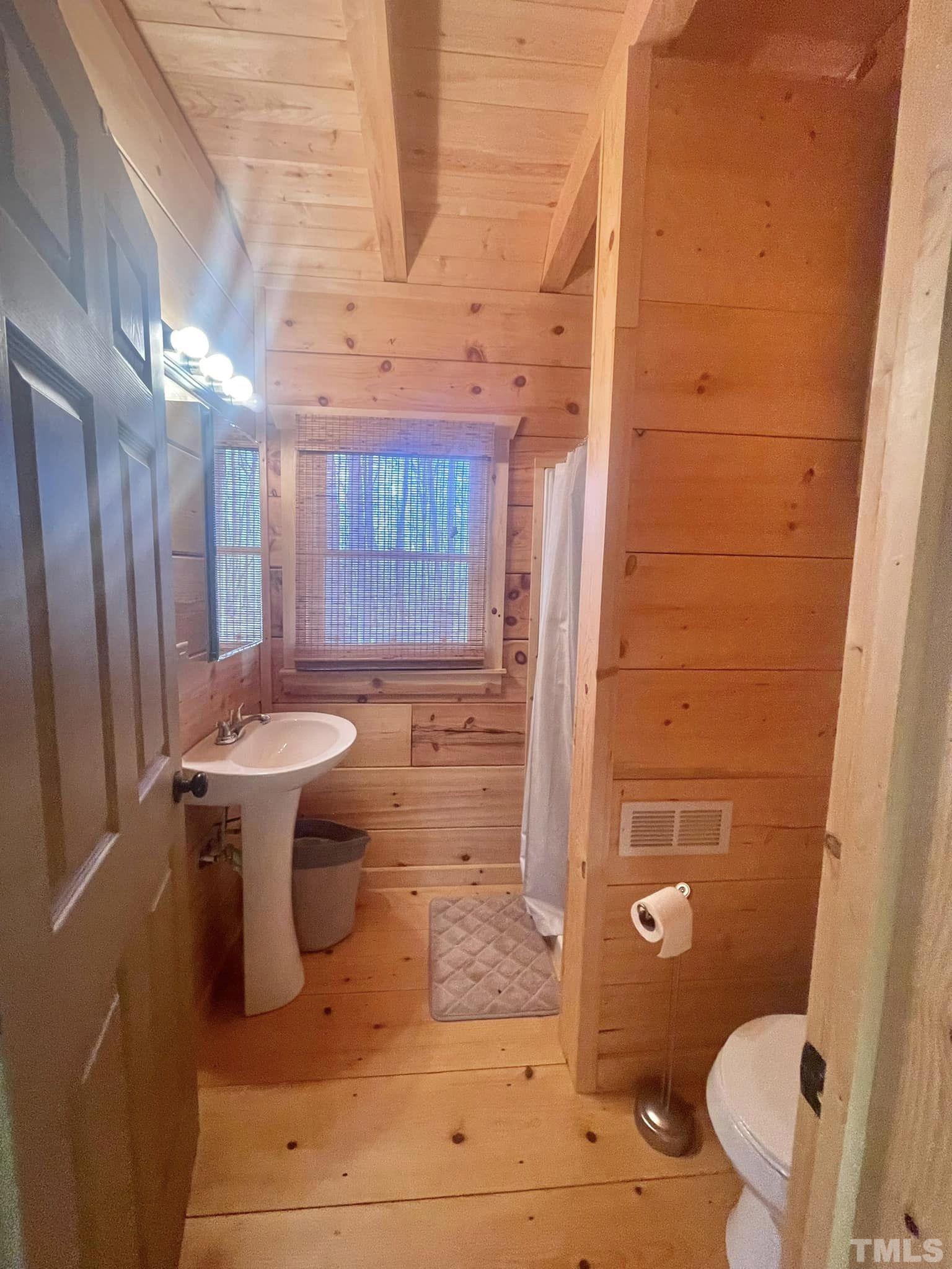 1183 John Allen Road Roxboro, NC 27574 - Photo 8 of 24 a bathroom with a sink a toilet and shower