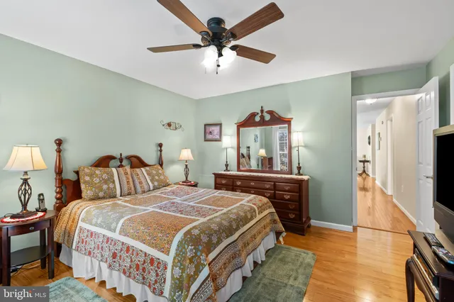 a bedroom with a bed and a flat tv screen on dresser