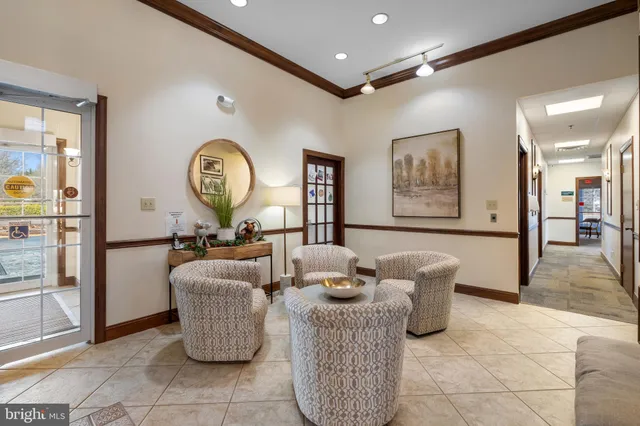 a view of a dining room with furniture and a book shelf