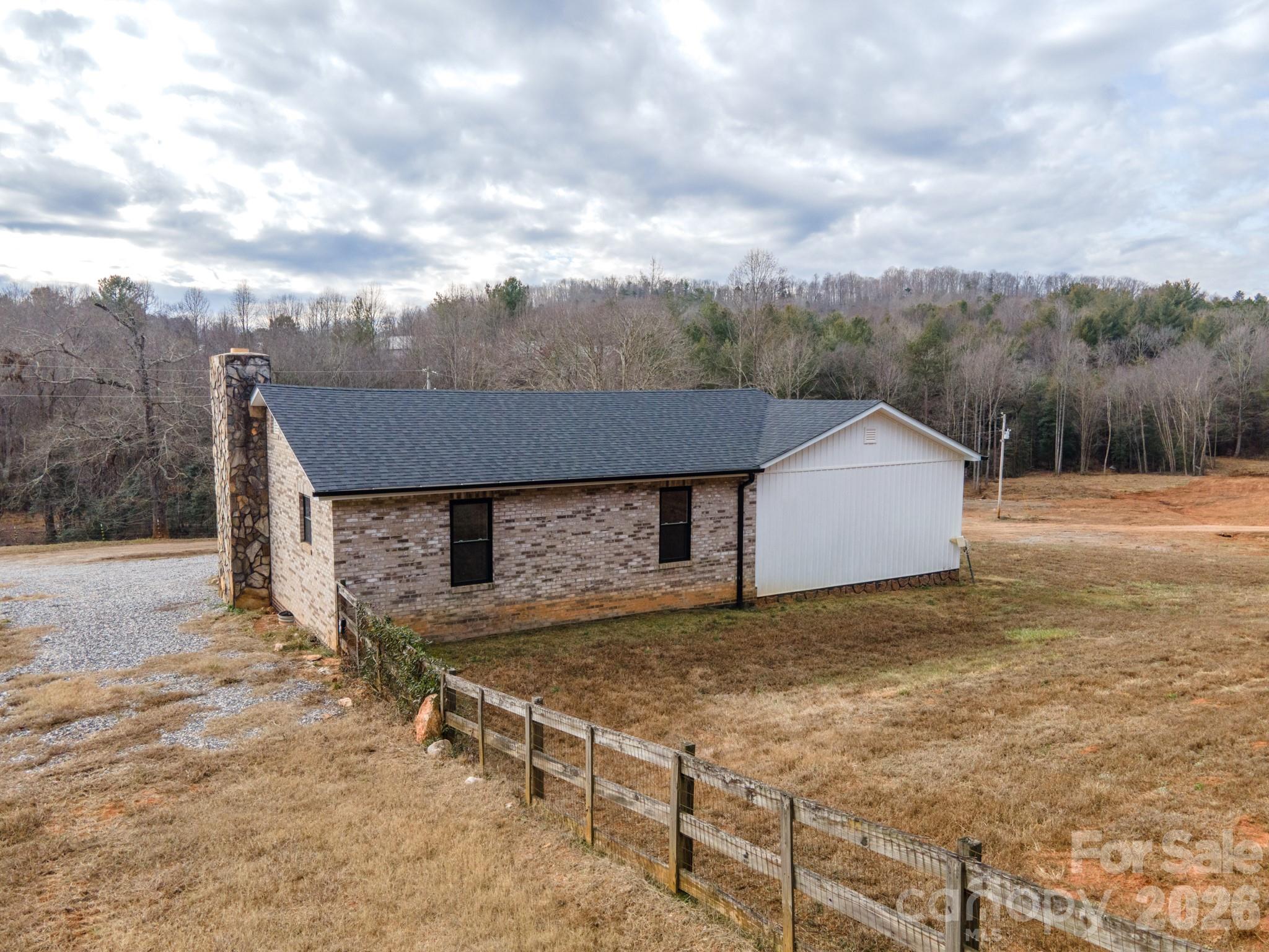 7400 Corn Hill Road Connelly Springs, NC 28612 - Photo 33 of 41 a view of a house with a yard and wooden fence