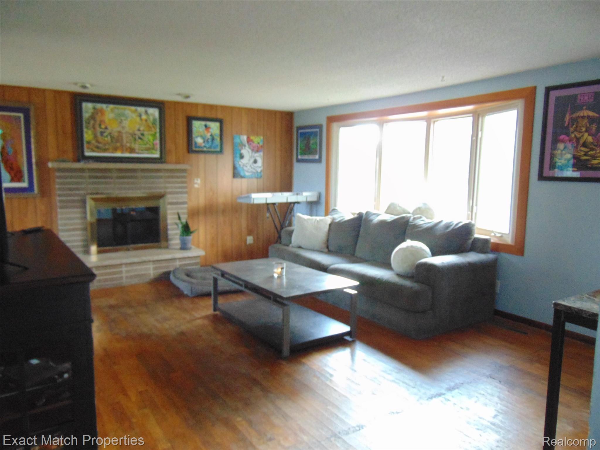 4886 North Stark Road Hope, MI 48628 - Photo 3 of 16 Living Room has Hardwood floors, Bay Window and Natural Fireplace....