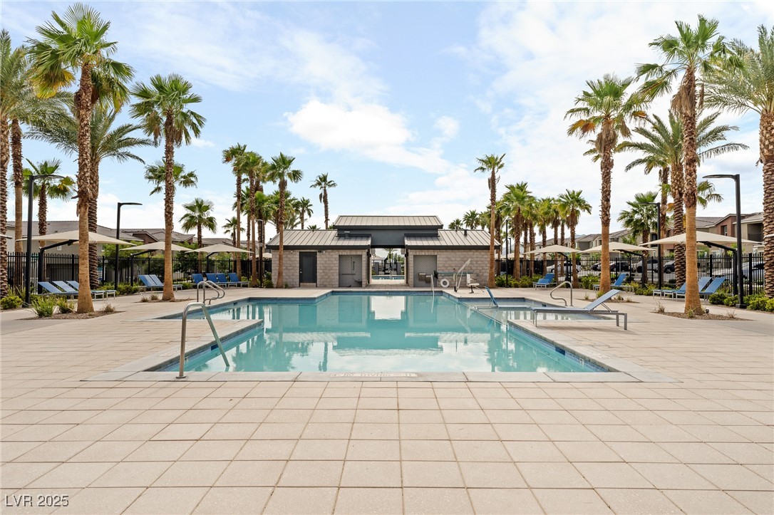 12126 Azure Gate Road, Unit 1 Las Vegas, NV 89183 - Photo 32 of 36 Community pool featuring a patio area and fence