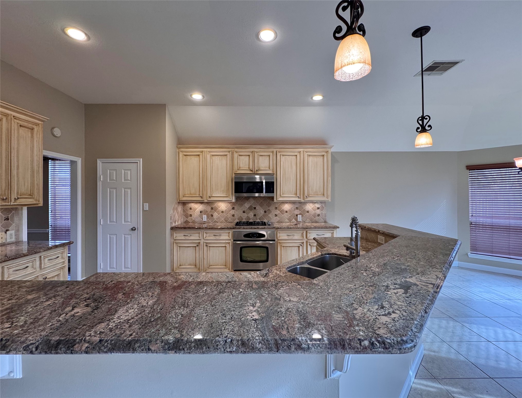 17243 Rush Trace Court Houston, TX 77095 - Photo 11 of 49 a kitchen with stainless steel appliances granite countertop a sink a stove counter space and cabinets