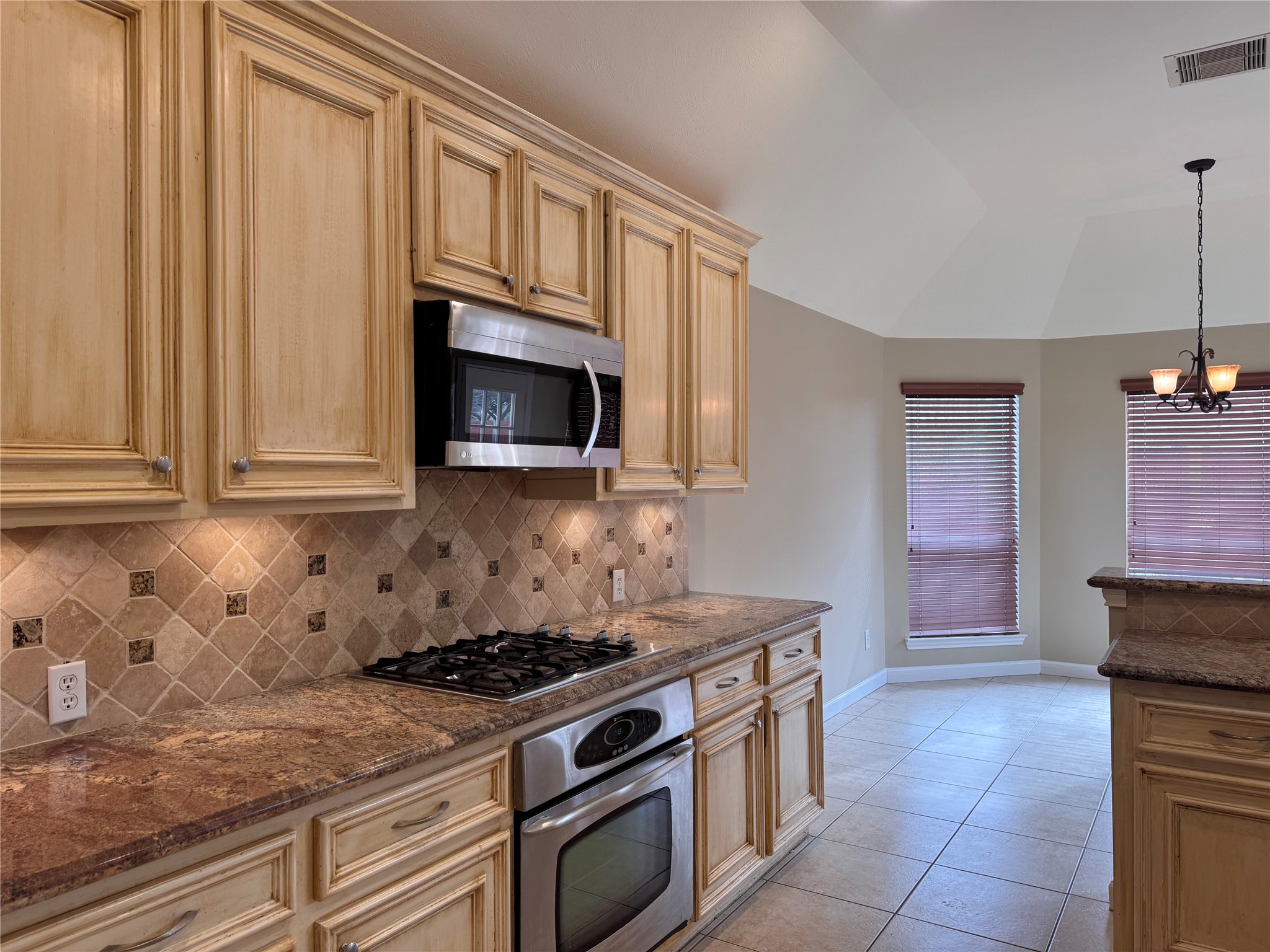 17243 Rush Trace Court Houston, TX 77095 - Photo 17 of 49 a kitchen with granite countertop a stove and a sink