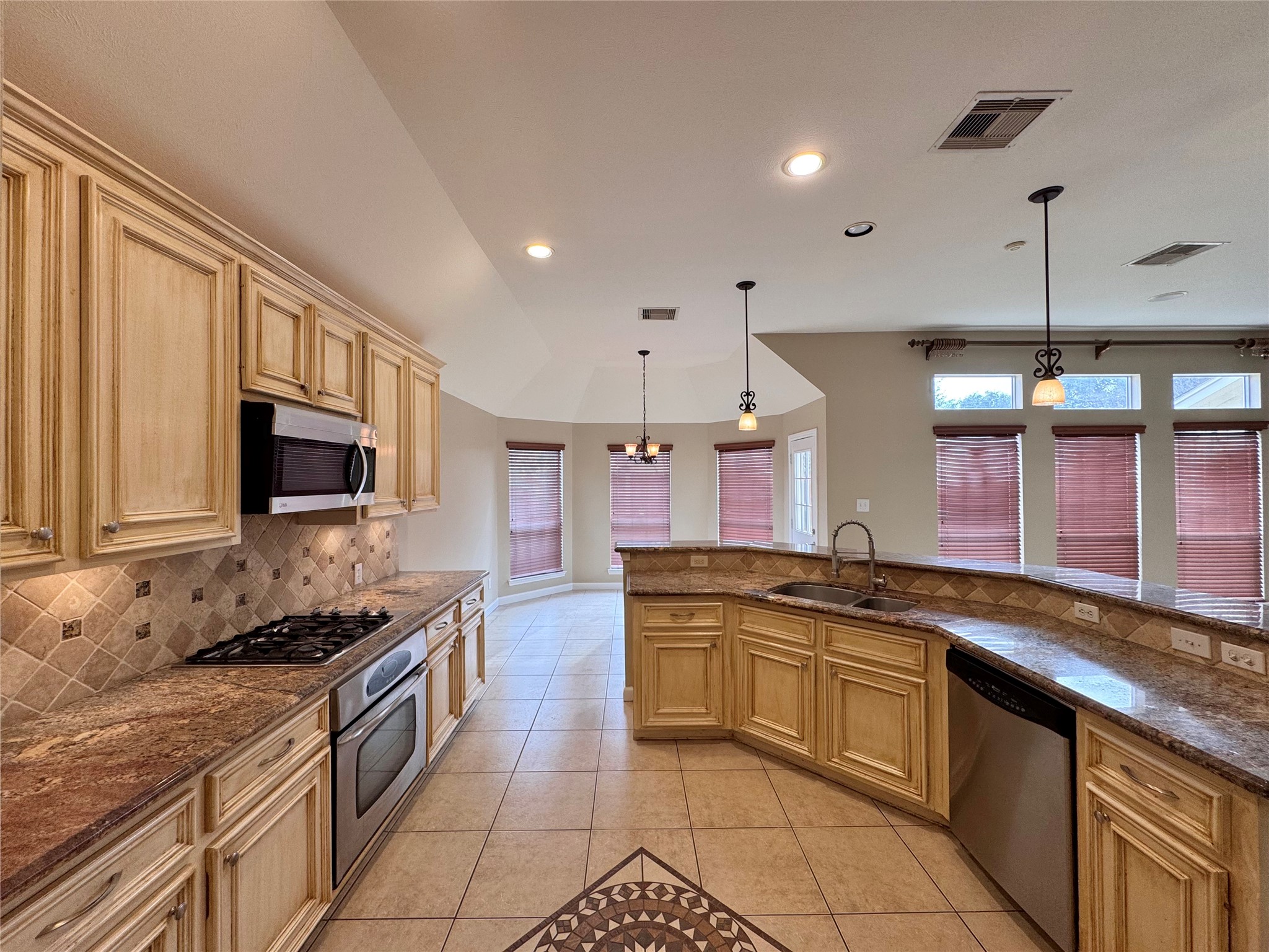 17243 Rush Trace Court Houston, TX 77095 - Photo 18 of 49 a kitchen with a sink stove and microwave