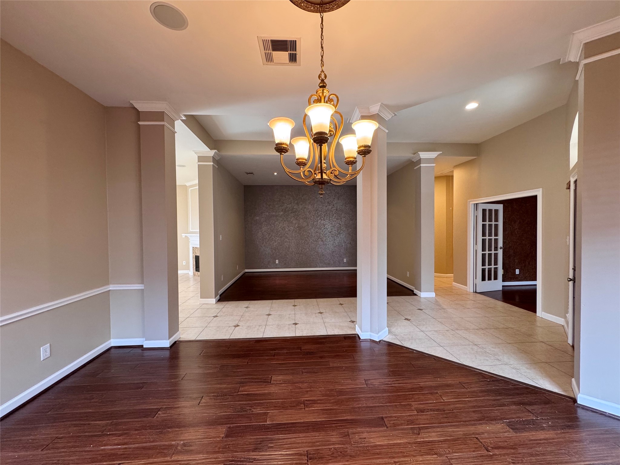 17243 Rush Trace Court Houston, TX 77095 - Photo 22 of 49 a view of a livingroom with wooden floor and chandelier