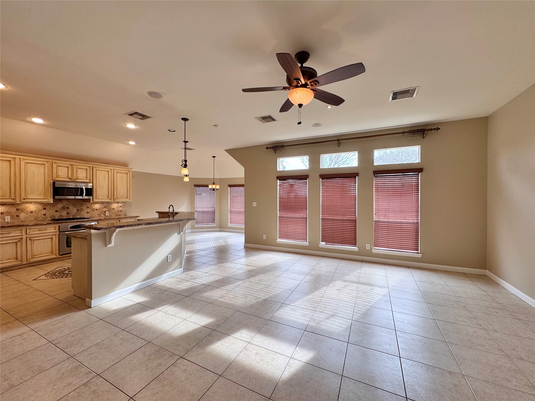 17243 Rush Trace Court Houston, TX 77095 - Photo 24 of 49 a view of a kitchen with kitchen island granite countertop a refrigerator cabinets and a sink
