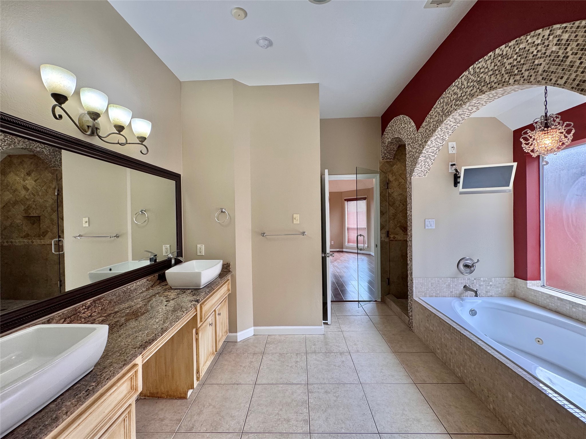 17243 Rush Trace Court Houston, TX 77095 - Photo 28 of 49 a spacious bathroom with a granite countertop sink and a mirror