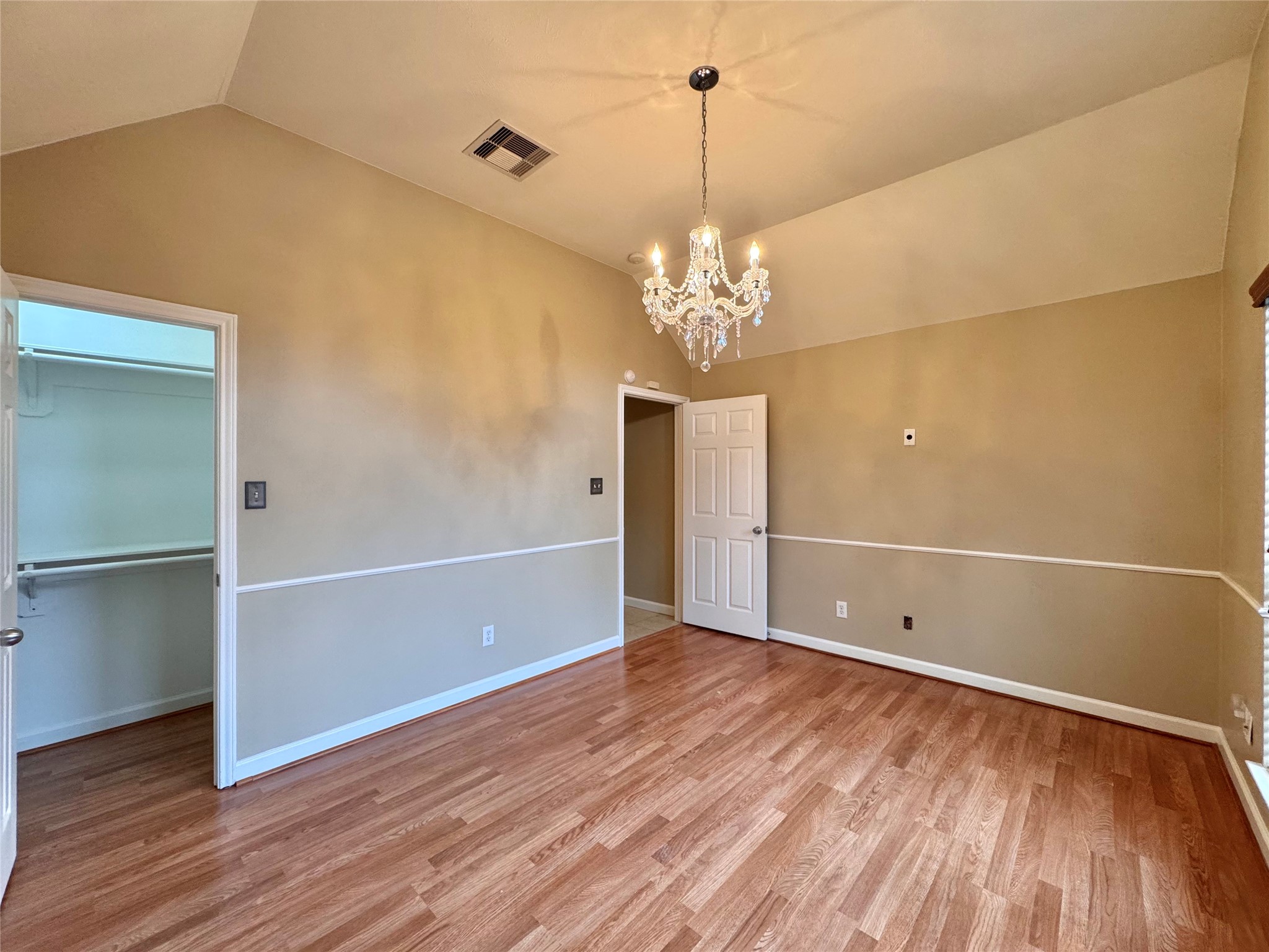17243 Rush Trace Court Houston, TX 77095 - Photo 43 of 49 a view of an empty room with wooden floor and chandelier