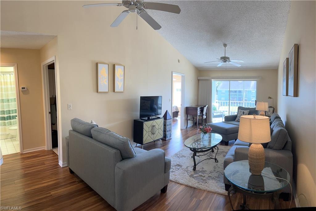 185 Grand Oaks Way, Unit R204 Naples, FL 34110 - Photo 1 of 18 a living room with furniture and a wooden floor