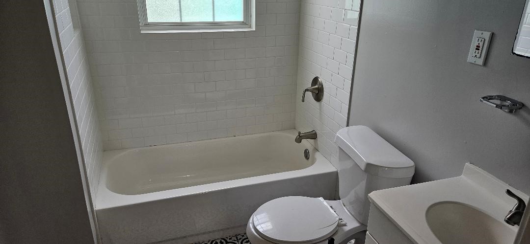 932 Walling Street Houston, TX 77009 - Photo 14 of 14 a bathroom with a toilet bathtub and shower
