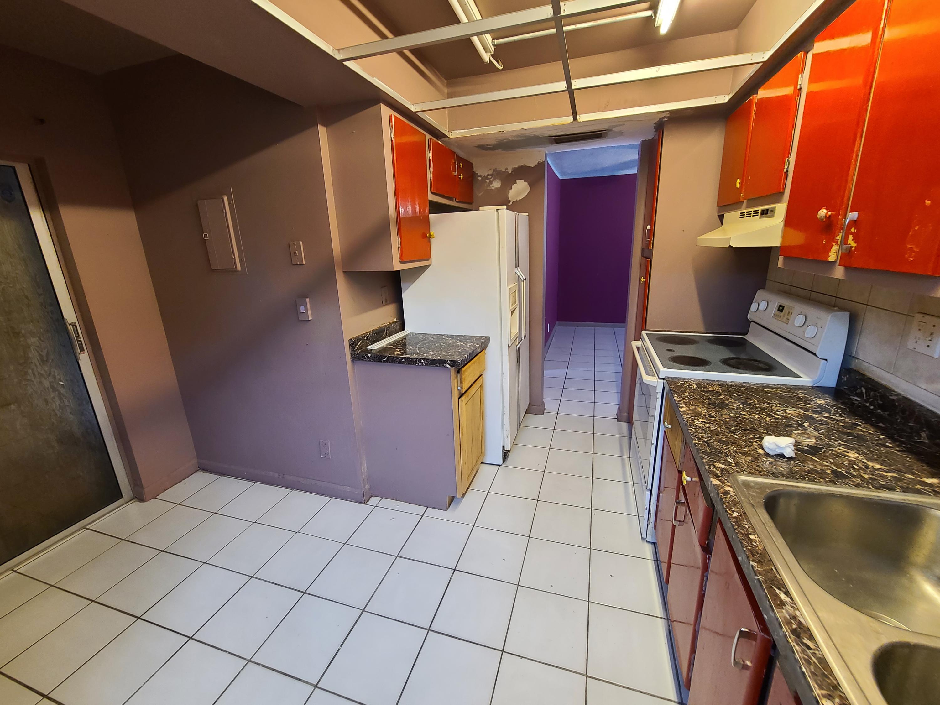 a kitchen with a stove top oven cabinets and a sink