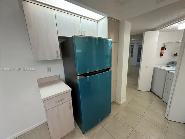 a kitchen with a refrigerator and a sink