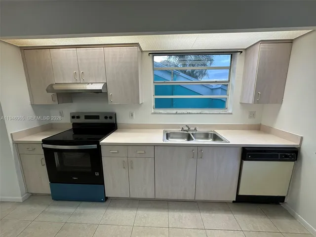 a kitchen with a stove and a sink