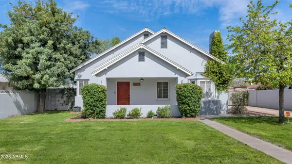 a front view of house with a garden