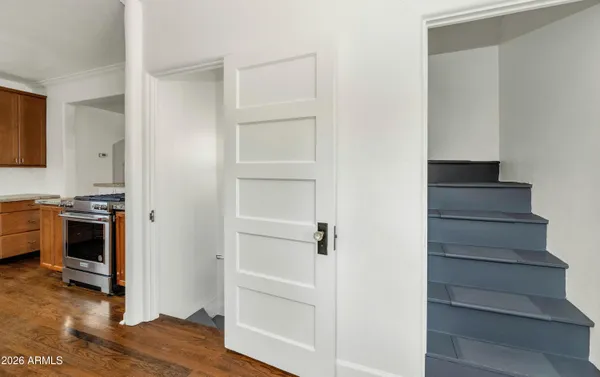 a view of kitchen and hallway with wooden floor