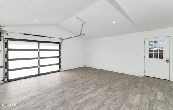 an empty room with windows and closet