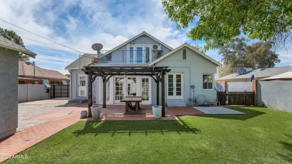 a view of a house with a yard patio and fire pit