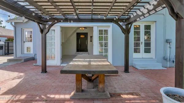 a view of a patio with table and chairs