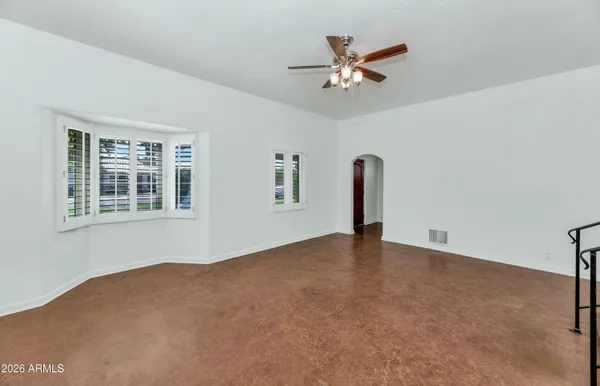a view of a livingroom with a ceiling fan and window