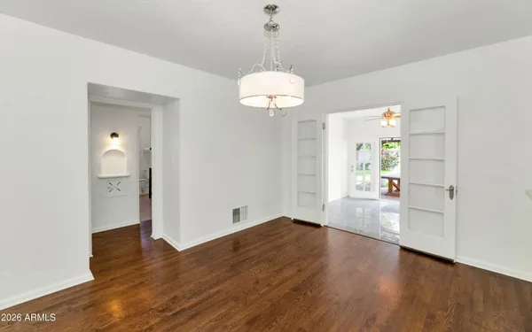 a view of empty room with wooden floor