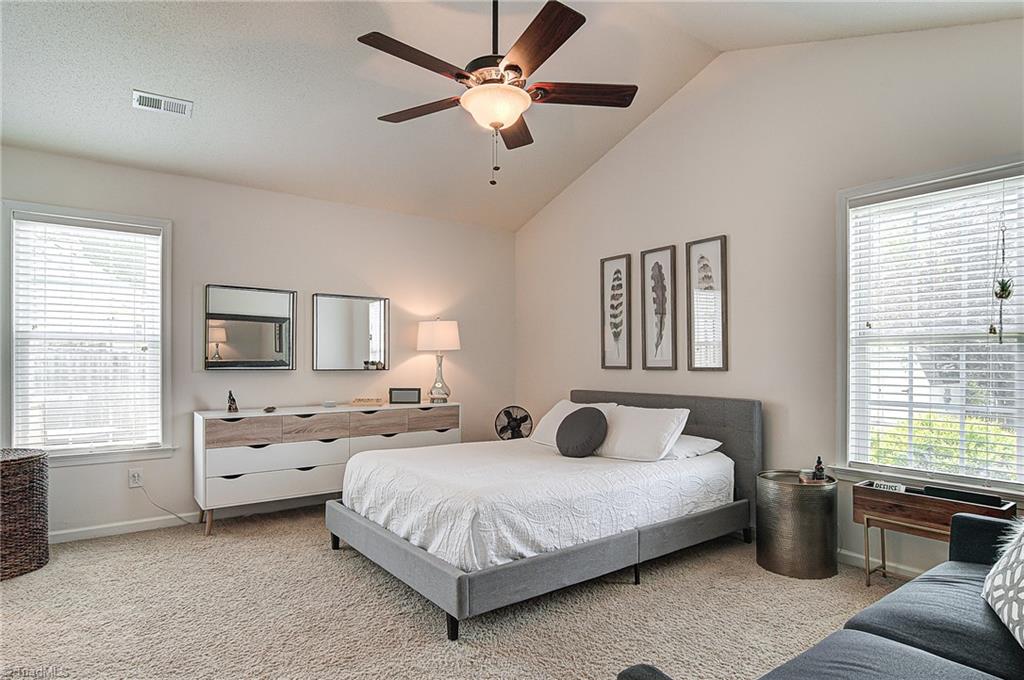 5605 Broadleaf Road Summerfield, NC 27358 - Photo 15 of 27 Master bedroom has a vaulted ceiling, en suite bath, and great natural light.