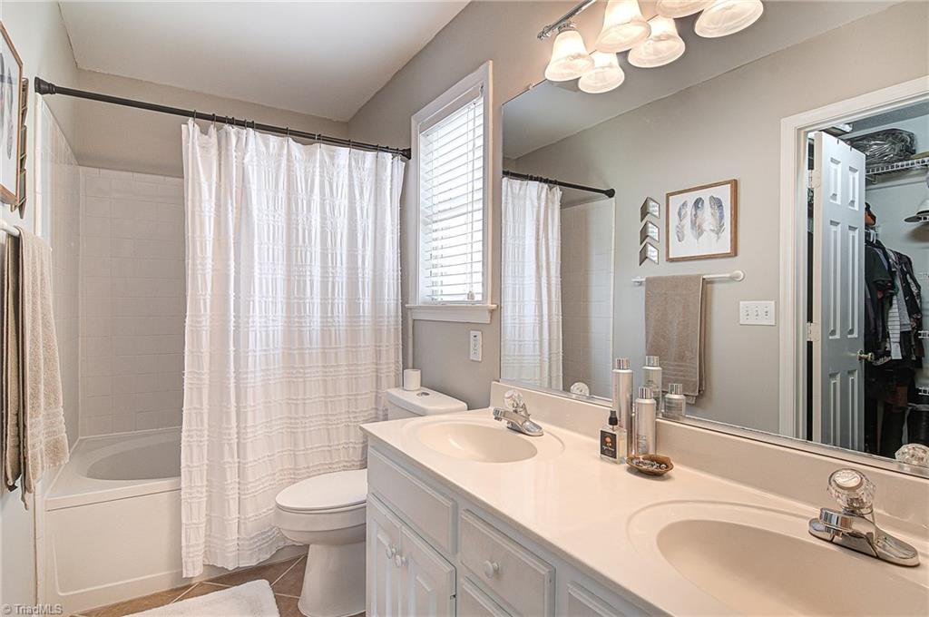 5605 Broadleaf Road Summerfield, NC 27358 - Photo 17 of 27 Master bath with tub/shower combo, double sinks, and a walk in closet