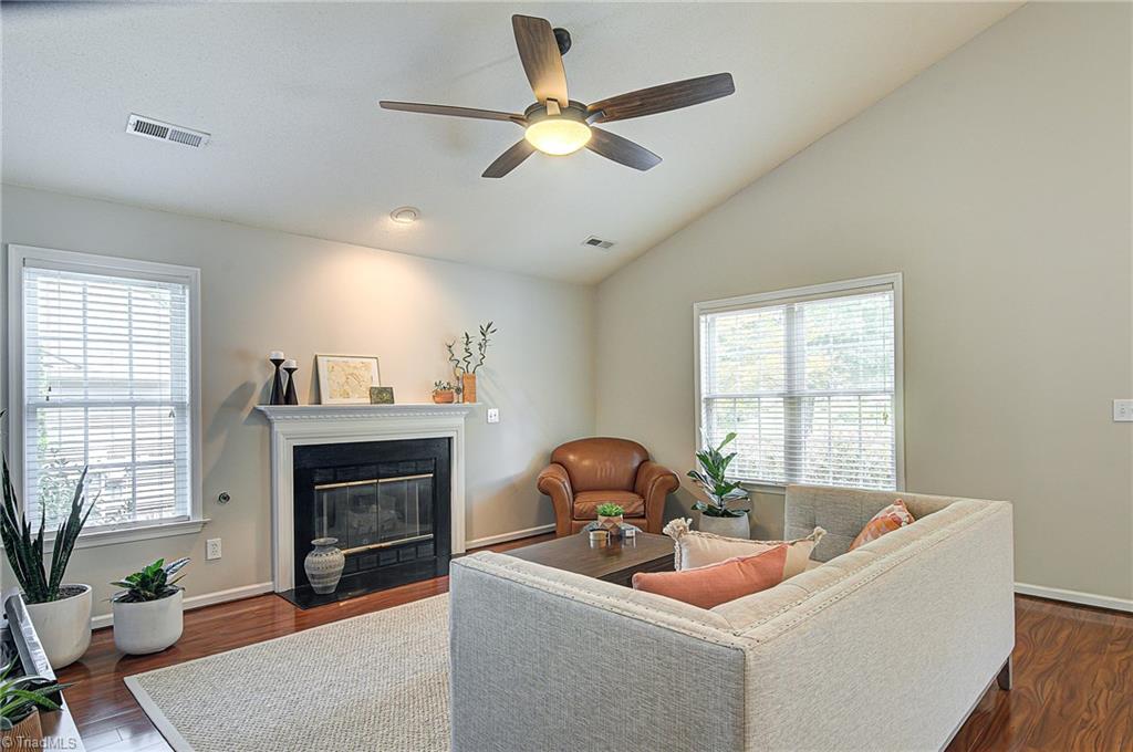 5605 Broadleaf Road Summerfield, NC 27358 - Photo 4 of 27 Living room features gas logs and a vaulted ceiling.