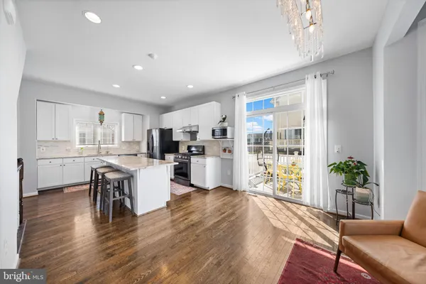 a kitchen with furniture and wooden floor