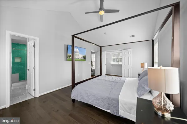 a bedroom with a large bed and a chandelier