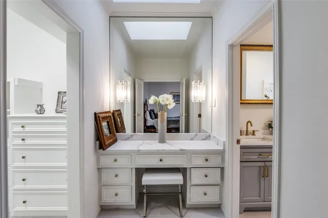 a bathroom with a sink a vanity and a mirror