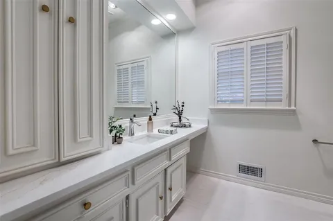 a bathroom with a sink a vanity and a mirror