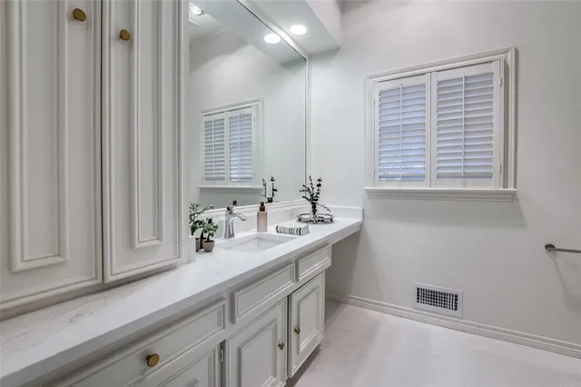 a bathroom with a sink a vanity and a mirror