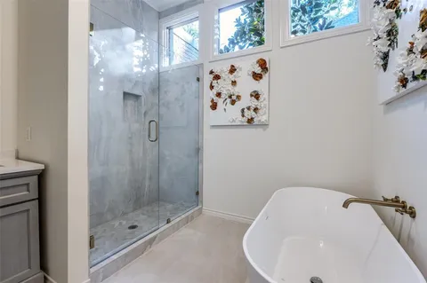 a bathroom with a bathtub and shower