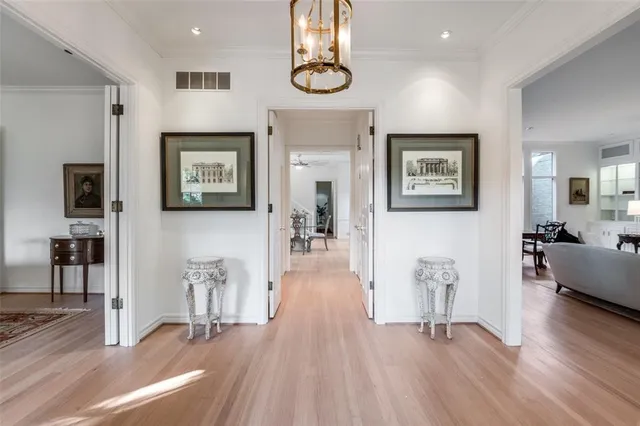 a view of a livingroom with furniture wooden floor front door and windows