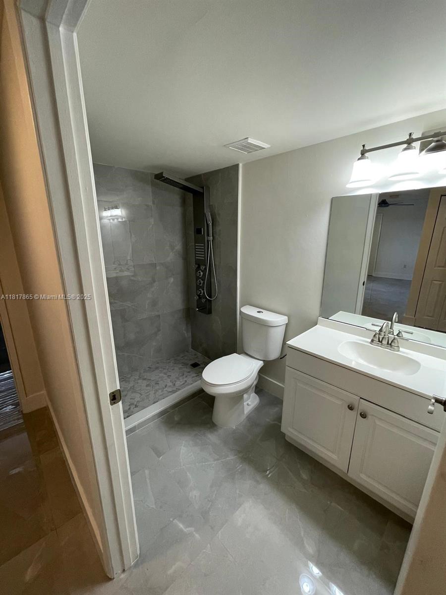 14921 Southwest 82nd Lane, Unit 19508 Miami, FL 33193 - Photo 11 of 31 a bathroom with a sink a toilet and shower