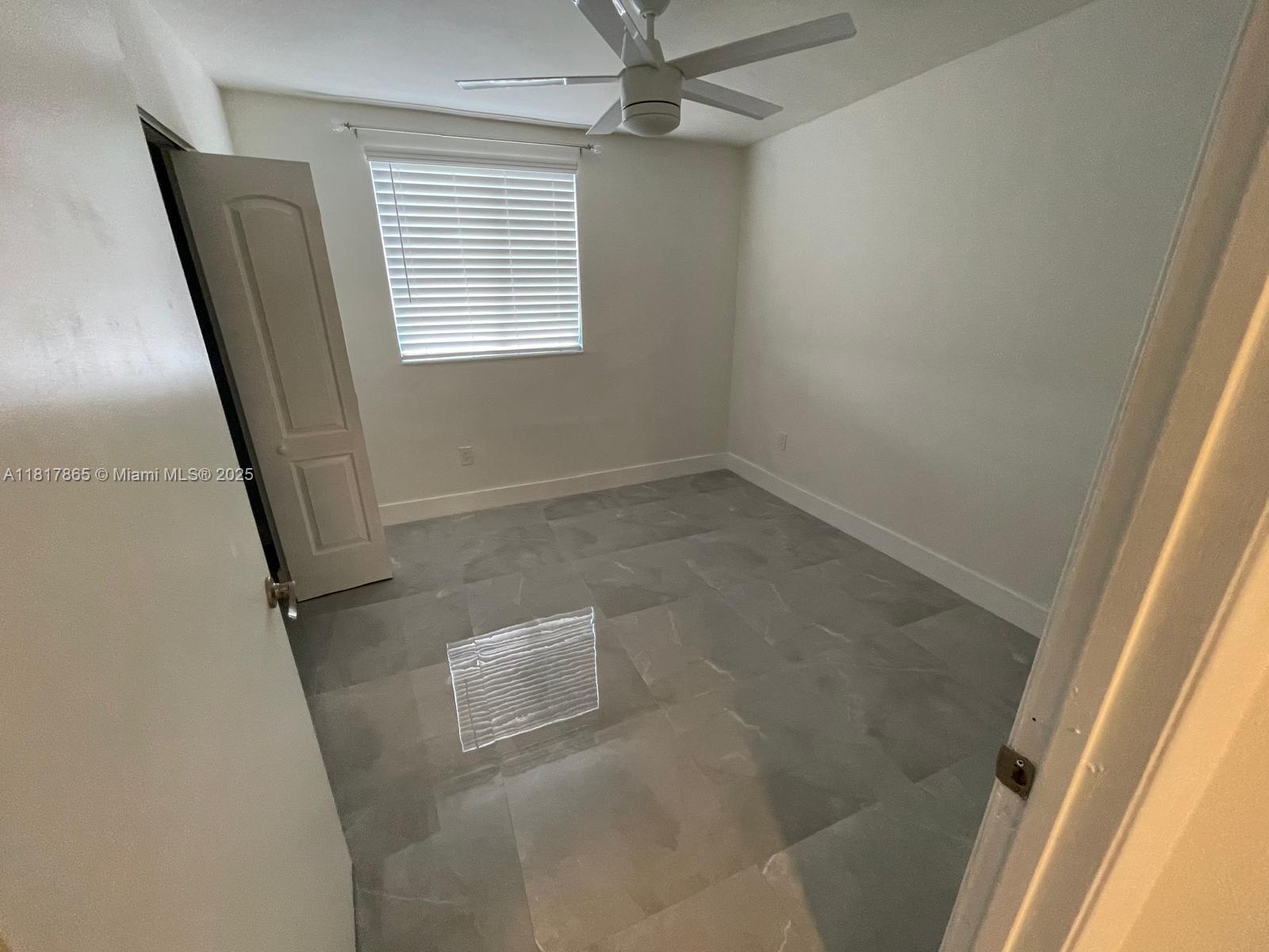 14921 Southwest 82nd Lane, Unit 19508 Miami, FL 33193 - Photo 12 of 31 an empty room with a window