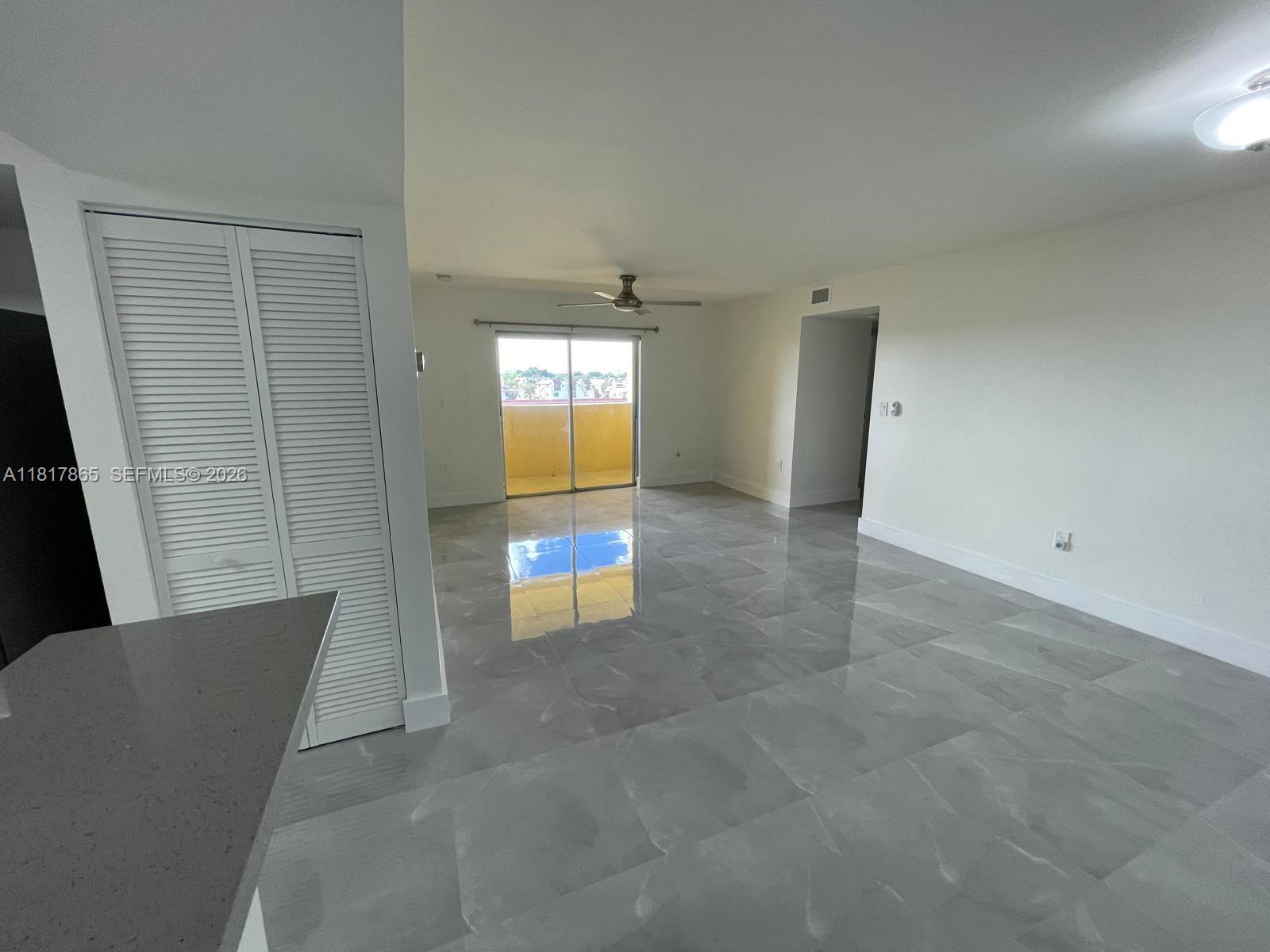 14921 Southwest 82nd Lane, Unit 19508 Miami, FL 33193 - Photo 3 of 31 a view of an empty room with a window