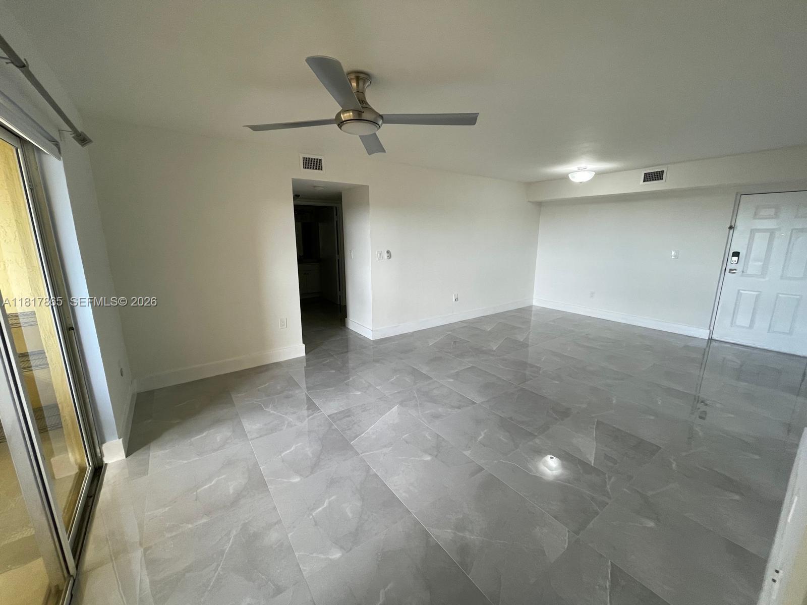 14921 Southwest 82nd Lane, Unit 19508 Miami, FL 33193 - Photo 7 of 31 an empty room with a empty space and windows