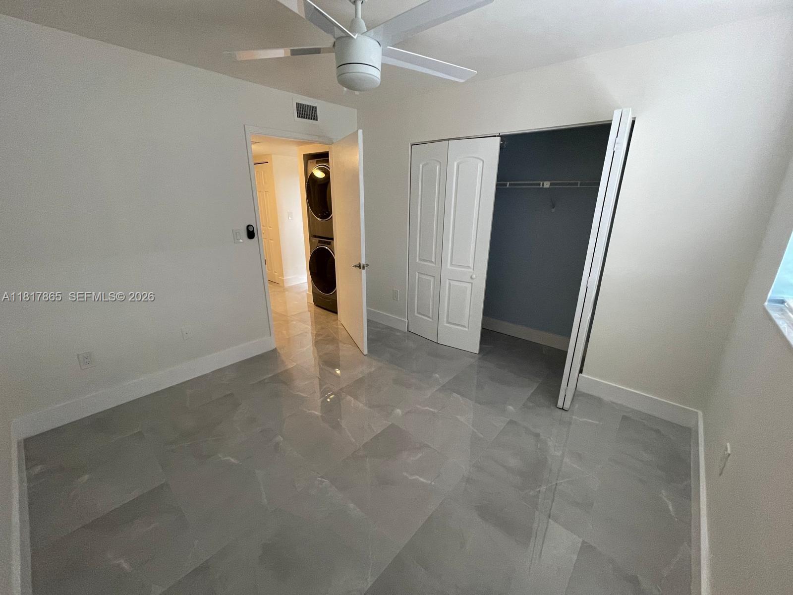 14921 Southwest 82nd Lane, Unit 19508 Miami, FL 33193 - Photo 9 of 31 an empty room with fan and entrance