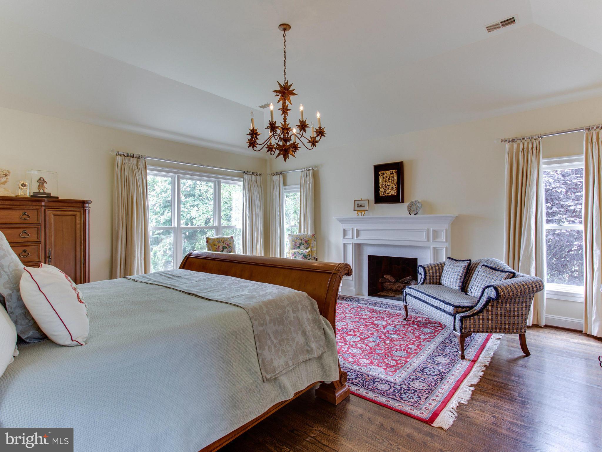1338 Kirby Road McLean, VA 22101 - Photo 17 of 30 a spacious bedroom with a bed and a fireplace