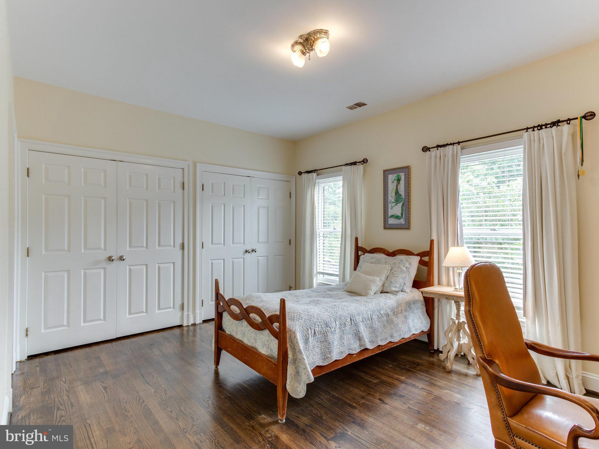 1338 Kirby Road McLean, VA 22101 - Photo 19 of 30 a bedroom with a bed and wooden floor