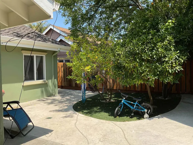 a view of a house with backyard and sitting area