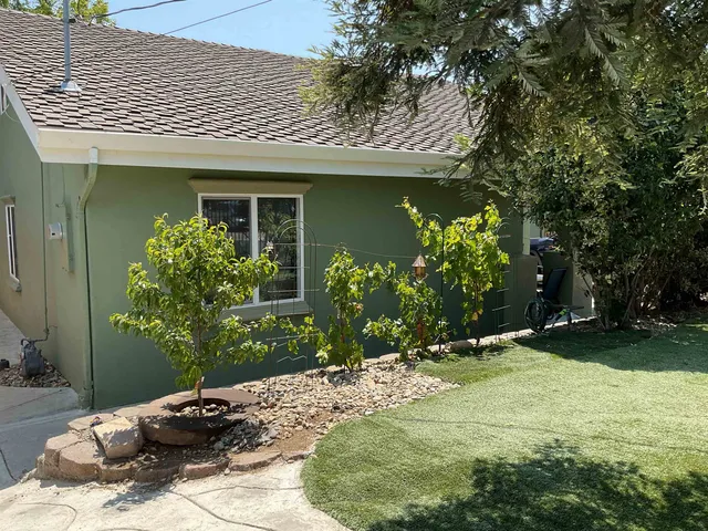a front view of a house with garden