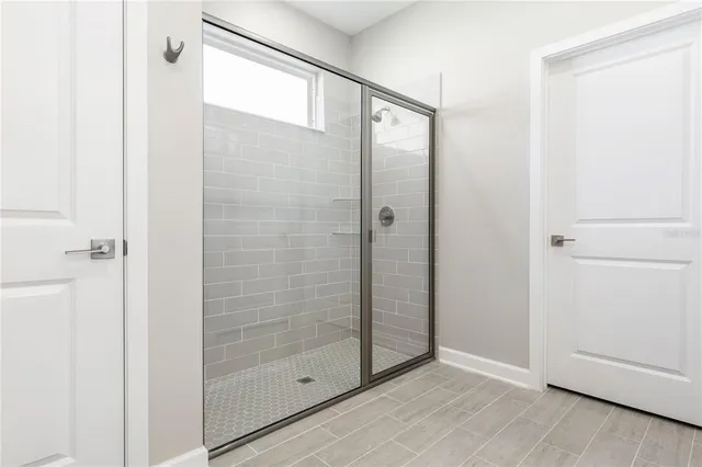 a bathroom with a glass shower door