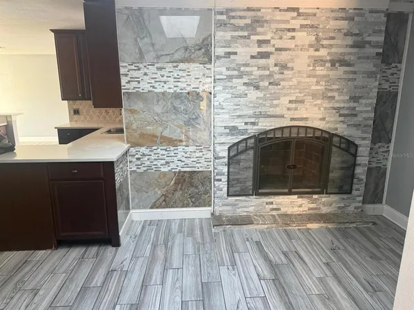 a hallway with fireplace and wooden floor
